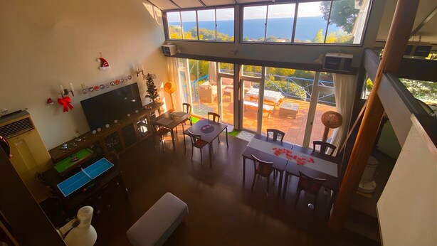 A spacious living area with a large window overlooking a patio.