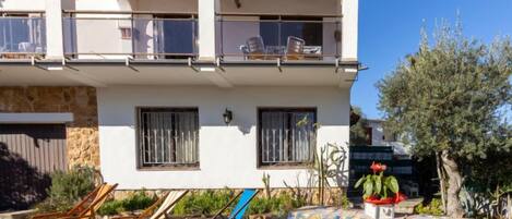 Relax on the covered patio with a lounge chair and enjoy the view from the upstairs balcony.