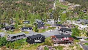 A residential area with houses, a road, and a mountain in the background. - Vacation home Solbu by Interhome (Eikerapen)