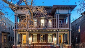 A two-story residential building with a balcony, a porch, and a visible entrance. - The Prohibition -Uniquely Designed Midtown Stunner (Kansas City)