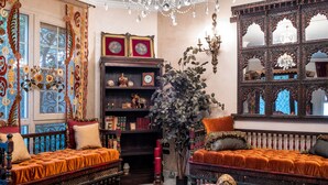 A richly decorated room with ornate furniture, a large mirror, and a chandelier. - Vesta - Mokattam Residence (Cairo)