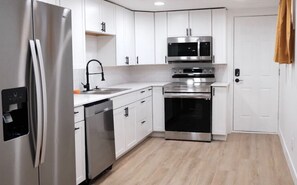 Enjoy cooking in this fully equipped kitchen with a refrigerator, dishwasher, microwave, and oven.