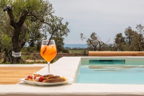 Relax by the serene pool overlooking the ocean and enjoy a refreshing drink and light meal.