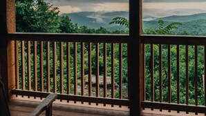A wooden deck with a railing overlooking a lush green landscape with mountains in the distance. - Buffalo River Cabin w/ Hot Tub (Ponca)