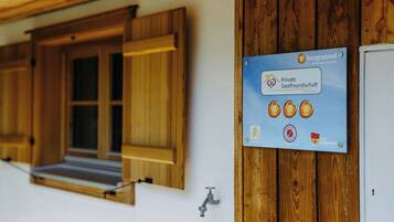 A sign for a private guesthouse in Burgenland, Austria, with a bicycle symbol indicating bike-friendly accommodation.