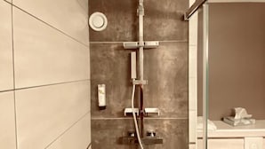 A modern bathroom with a shower, tiled walls, and a glass partition. - Logis Hotel Altitude et Spa (Pexonne)