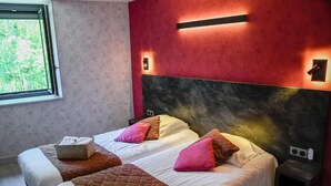 A hotel room with two beds, a large window, and a red accent wall. - Logis Hotel Altitude et Spa (Pexonne)