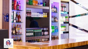 A hotel bar with shelves stocked with various beverages, including alcohol and soft drinks.