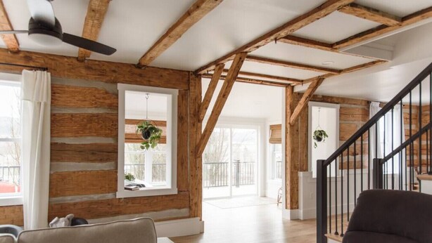 A spacious living area with exposed wooden beams, a ceiling fan, and a staircase leading to another level. - Secluded Valley Oasis with Swimming Pond, Spa, Firepit, 3BD/2BA, Family friendly (Liverpool)