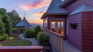 A house with a covered patio, a gazebo, and a view of the mountains. - Eagle's Nest Lodge and Apts (Whittier)