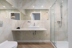 Apartamento luxo | Banheiro | Chuveiro, secador de cabelo, toalhas de banho, papel higiênico