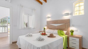 A hotel room with a bed, bedside tables, a window, and a view of the outside. - Villa Amanecer - Plus (Calpe)