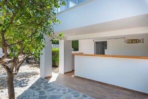 A modern reception area with a wooden counter and a wall-mounted sign that reads 'BEACH'.