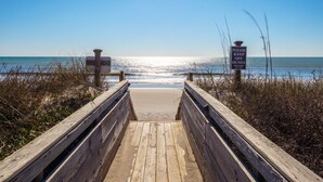 A wooden boardwalk leading to a beach with a sign that reads "PLEASE KEEP OFF DUNES NTP ORDER $500 FINE". - Topsail Pearl #132 – Oceanfront Retreat with Beach Access & Sound Views (North Topsail Beach)
