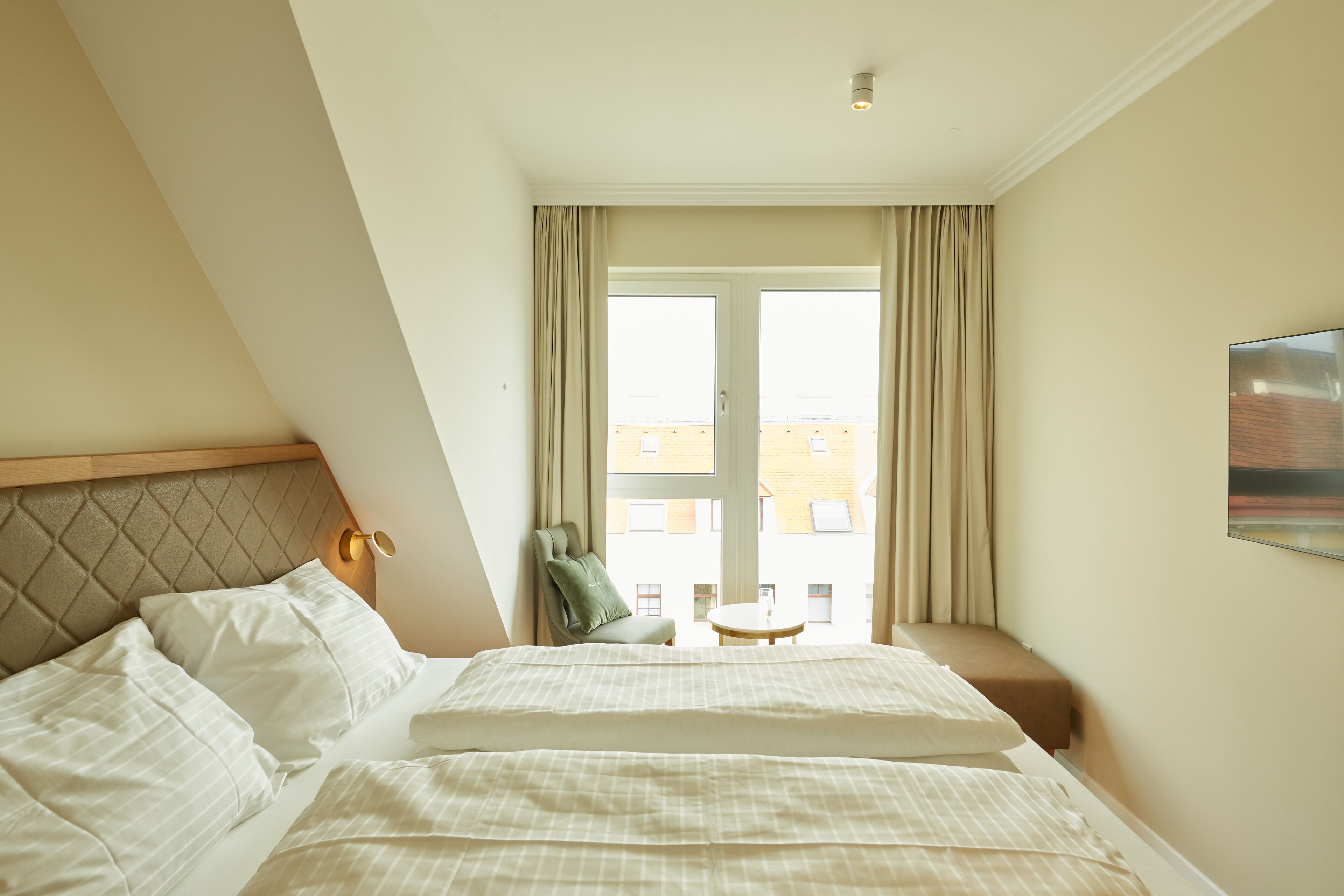 Premium bedding, laptop workspace, blackout drapes, soundproofing