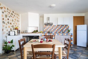 Fridge, microwave, coffee/tea maker, cookware/dishes/utensils