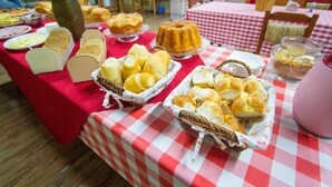 A buffet table with various breads and pastries.