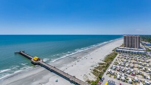 An aerial view of a beach with a pier, a hotel, and a parking area. - SkyHigh Ocean Front Margate Tower (Myrtle Beach)