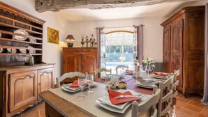 A dining area with a wooden table set for four, surrounded by chairs. - La Renardière by Interhome (Le Tignet)