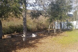 Relax in a serene natural setting surrounded by trees and shrubs along a winding pathway.