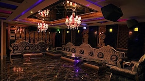 A luxurious room with ornate furniture, chandeliers, and a reflective floor. - Dele Grand Hotel (Xiangcheng)