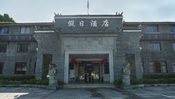 A traditional building with a stone facade and a sign above the entrance.