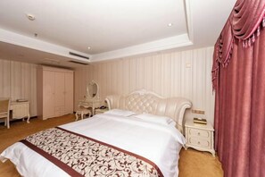 A spacious bedroom with a large bed, a vanity with a mirror, a chest of drawers, and a wardrobe. - Yaoli Holiday Hotel (Fuliang)
