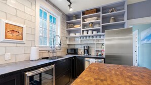 A modern kitchen with black cabinets, a wooden countertop, a stainless steel refrigerator, and a built-in microwave. - 8 Park l Dog Friendly l Outdoor Oasis l Mins to Beach (St. Augustine)