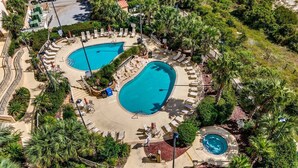 An aerial view of a resort with two large swimming pools surrounded by palm trees and lounge chairs. - Beautiful Ocean Front Margate Tower 4 Bedroom Condo (Myrtle Beach)