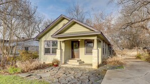 A single-story house with a stone-paved front yard, a front porch, and a small front yard with a potted plant. - Pet-Friendly Austin Home w/ Private Yard + Deck! (Austin)