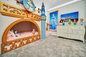 A child's bedroom with a castle-themed bed, a dresser, and Disney princess figurines. - EV_2900 - 9BR / 5BA Storey Lake Villa near to Disney, Private Pool & Games Room (Kissimmee)