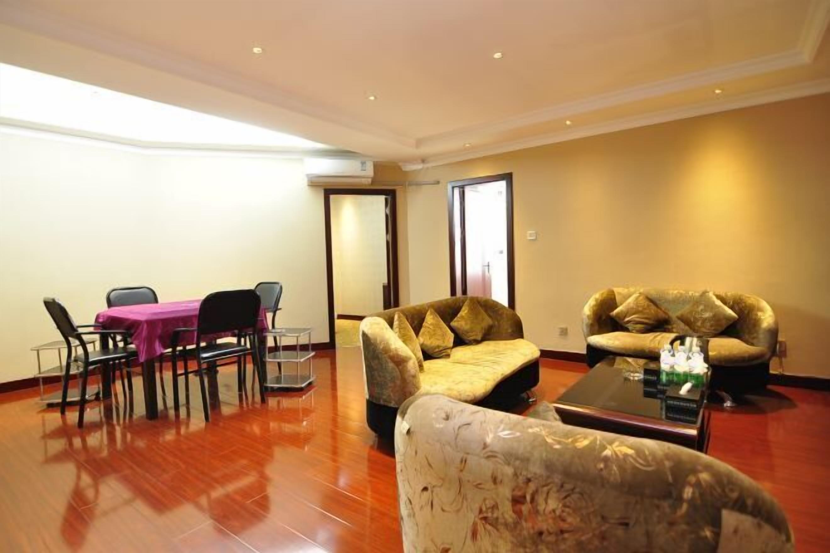 A spacious living room with a dining table, two sofas, and a coffee table.