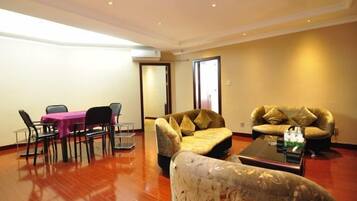 A spacious living room with a dining table, two sofas, and a coffee table.