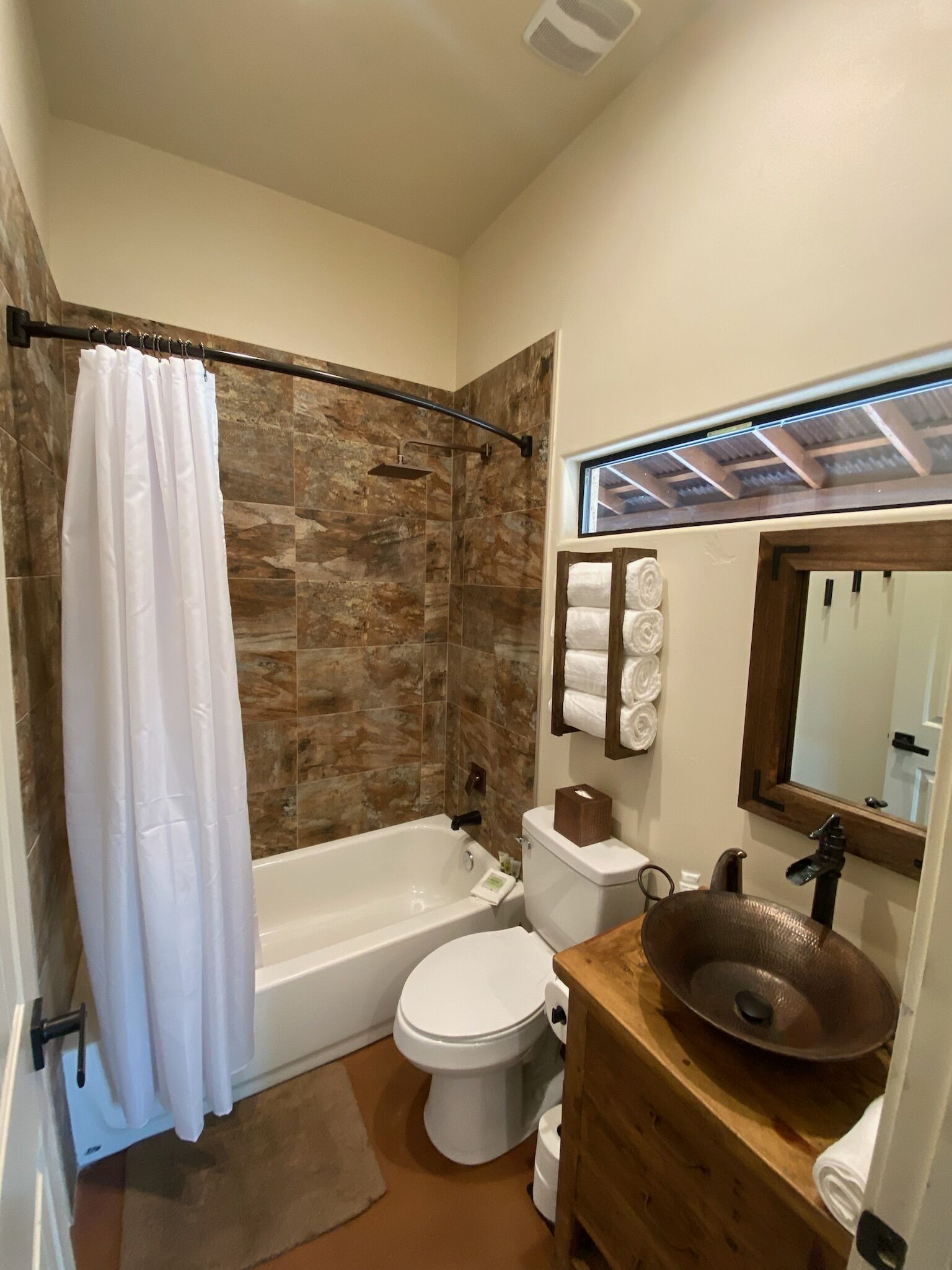 A bathroom with a bathtub, toilet, and sink.