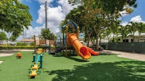 A playground with a slide and climbing structures. - Keys Paradise! (Key Largo)