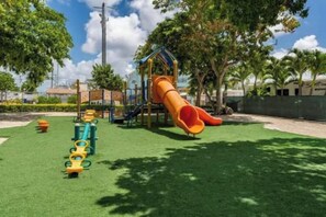 A playground with a slide and climbing structures. - Keys Paradise! (Key Largo)