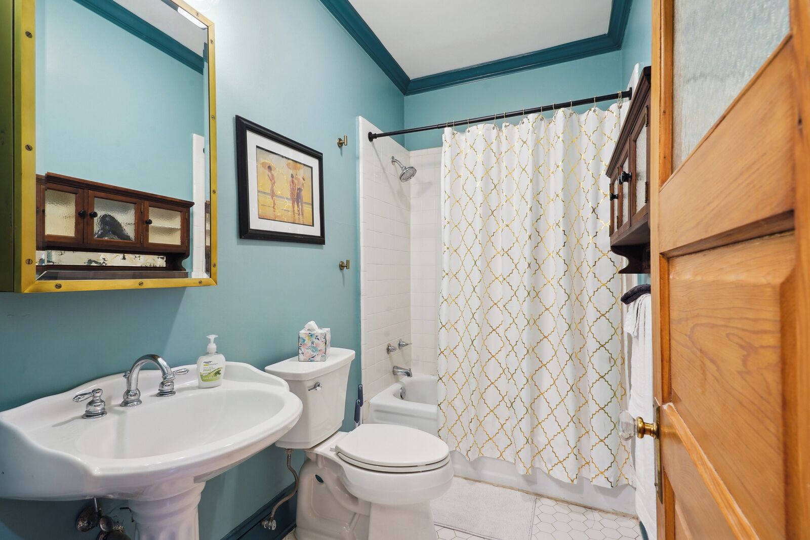 A bathroom with a sink, toilet, and shower curtain.