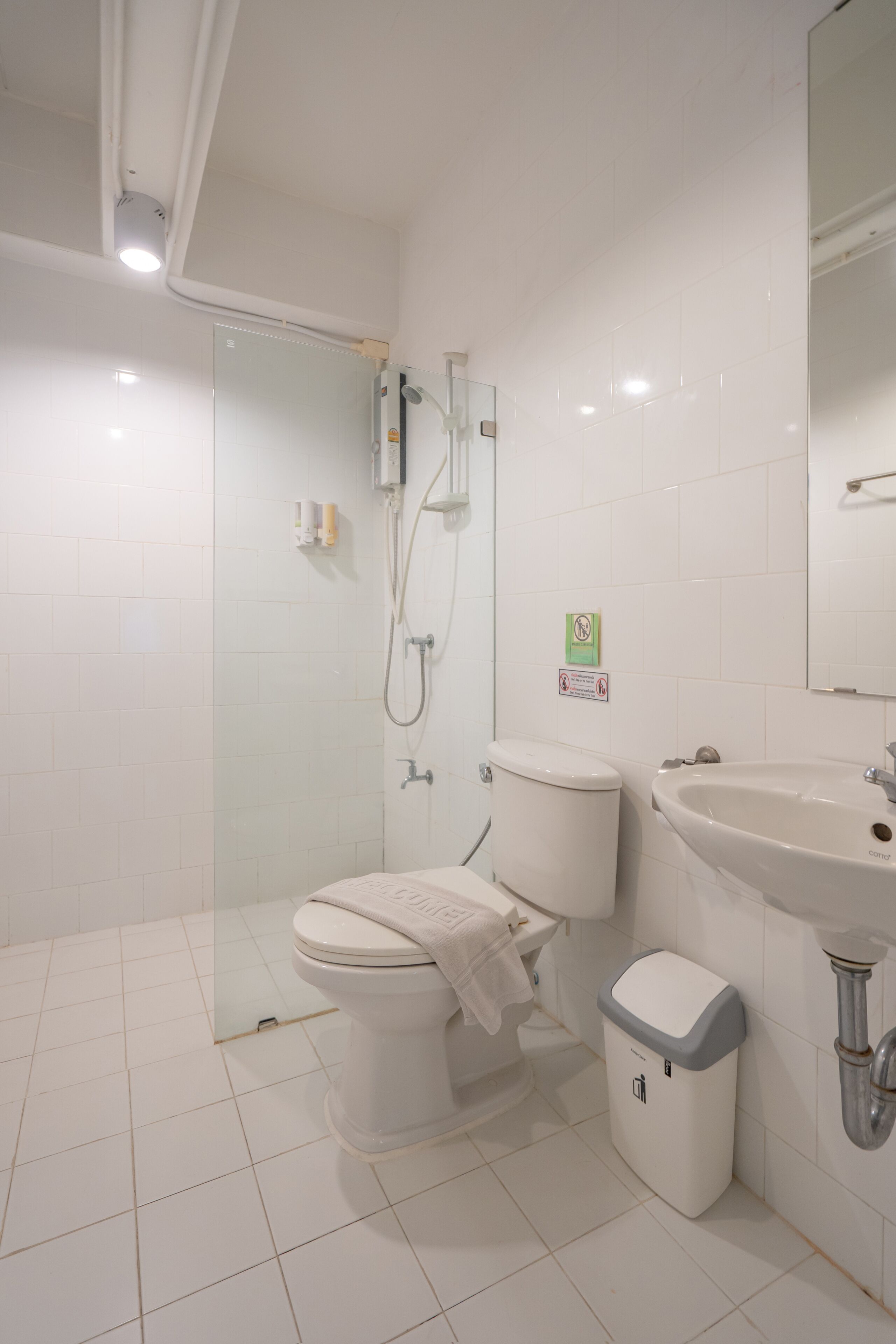 A modern bathroom with a toilet, bidet, and sink.
