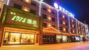 Un hotel con un llamativo letrero que dice '1974', varios pisos y ventanas iluminadas.