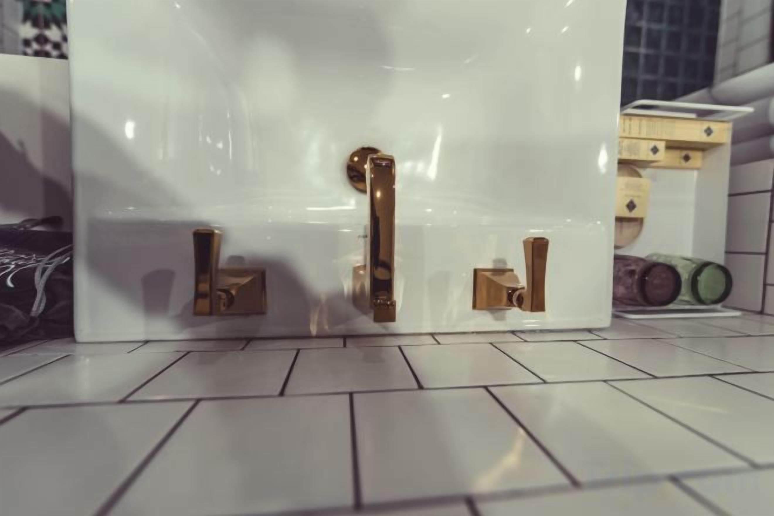 A white door with two brass handles and a small brass lock.