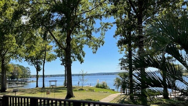 A view of a lake with a wooden deck and a flag. - Gone Fishing on Lake Wateree (Liberty Hill)