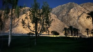 A mountainous landscape with a tree in the foreground and a clear sky. - Newly Renovated Home in Rivera (La Quinta)