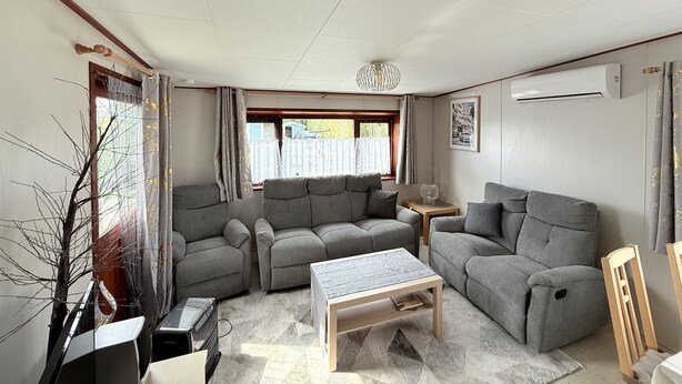 A living room with two grey sofas, a wooden coffee table, and a small side table. - Beach Resort Kamperland - 771 (Kamperland)
