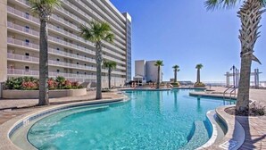 A hotel with a large pool, palm trees, and a clear blue sky. - “Just Breathe”It’s all about the view & location! Sleeps 7.  (Panama City Beach)