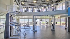 A multi-level gym with various exercise equipment, large windows, and a high ceiling. - “Just Breathe”It’s all about the view & location! Sleeps 7.  (Panama City Beach)