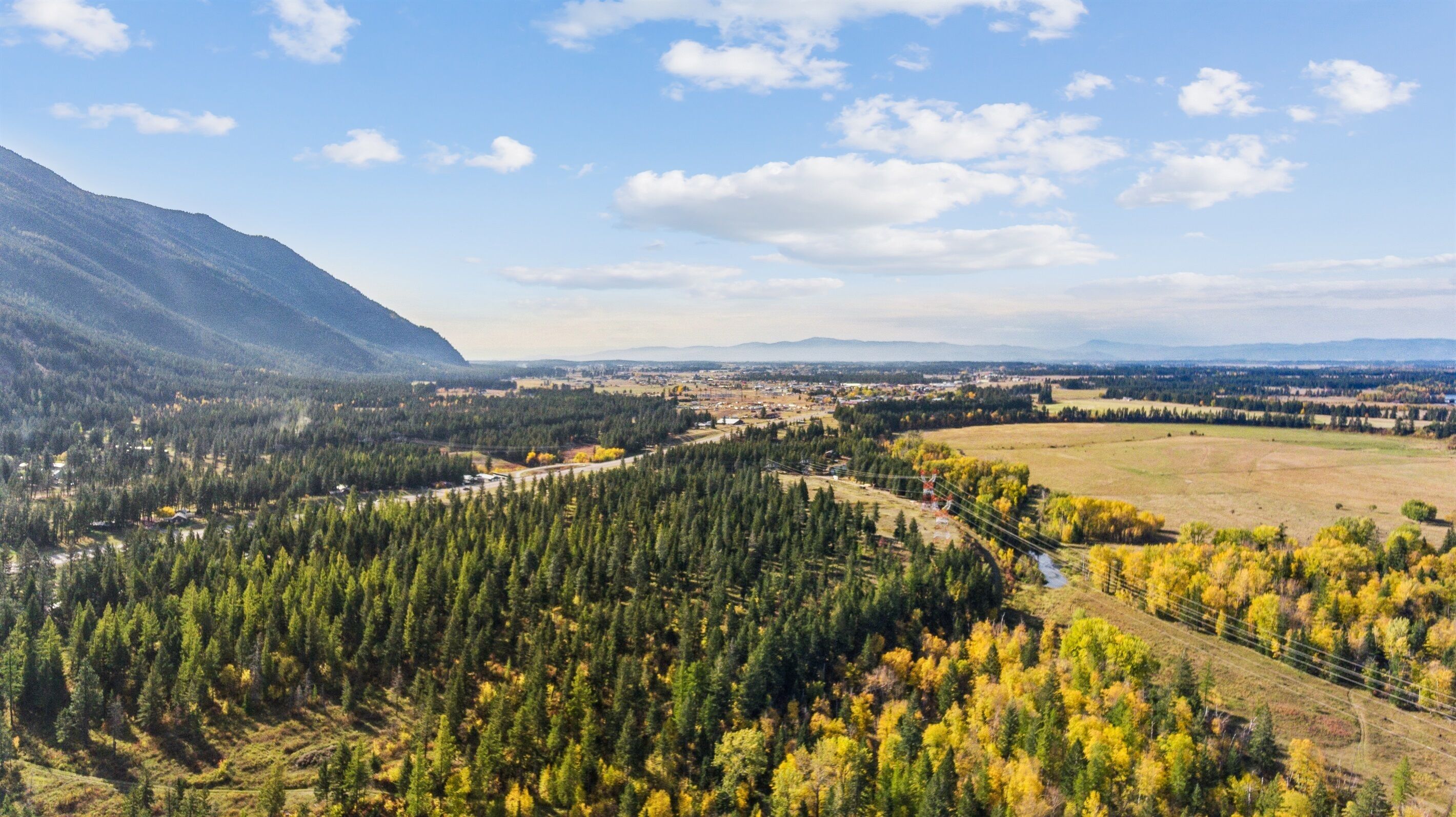 A panoramic view of a mountainous landscape with a town nestled in the valley.