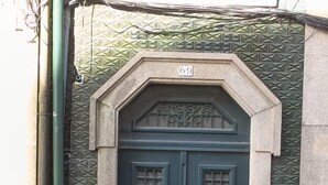 A dark green door with a decorative top and a number '69' above it. - Porto Brasil Hostel (Porto)