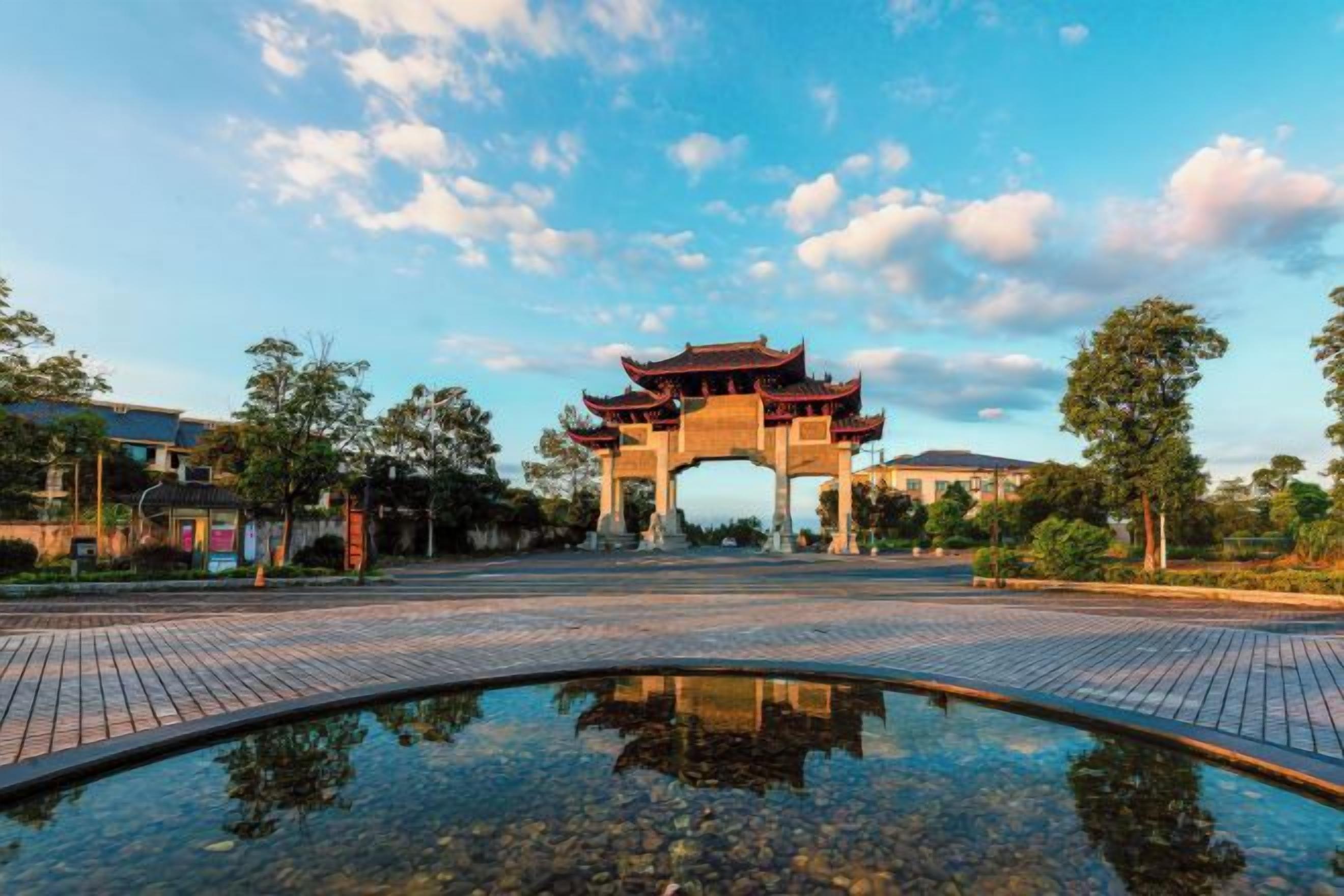 A traditional archway with a reflection in a water feature.