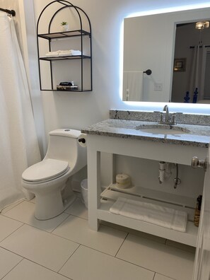 Habitación Deluxe, 1 cama de matrimonio grande | Baño | Ducha, secador de pelo, toallas y jabón