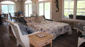 A cozy bedroom with a large bed, a sitting area with a bench, and a dining area with chairs. -  Desert Rose Villa, with Fabulous Coral Harbor views (Coral Bay)